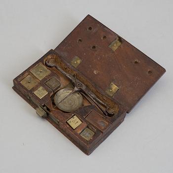 An iron scale and brass weights, 18th/19th century.