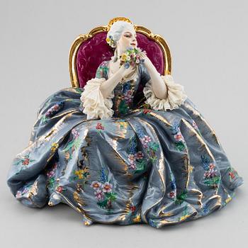A porcelain figurine of a seated Rococo lady, 20th century, Italy.