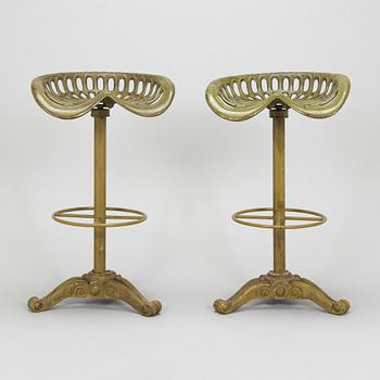 Four bar stools, painted cast iron, partly from the early 20th century.