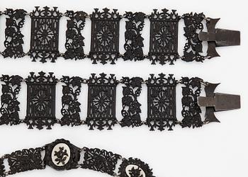 A Berlin steel and iron parure comprising a necklace, two bracelets and a brooch.