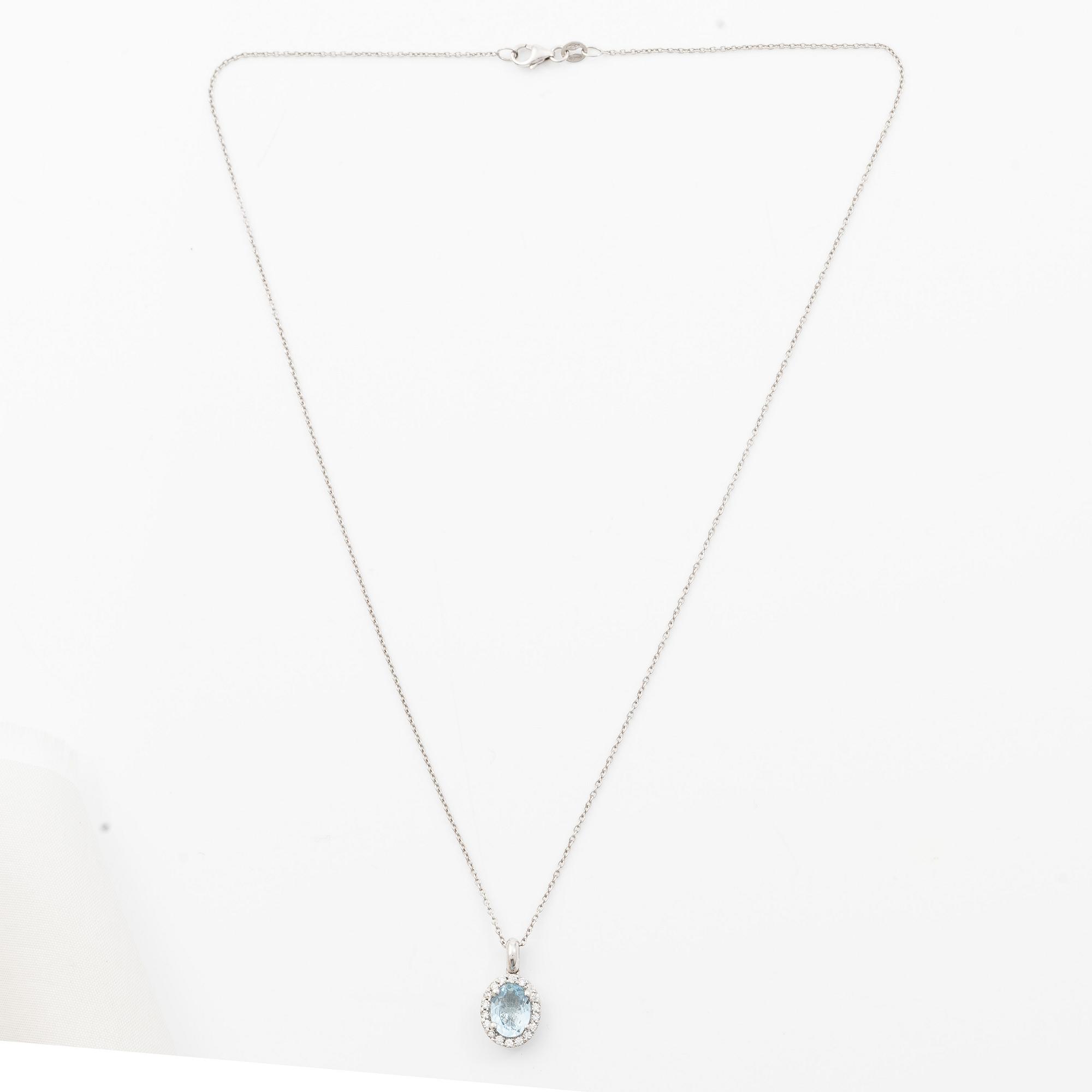 Pendant with chain in 18K white gold set with a faceted aquamarine and round brilliant-cut diamonds.