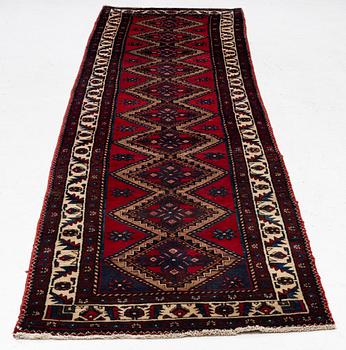 An oriental runner, c. 395 x 100 cm.