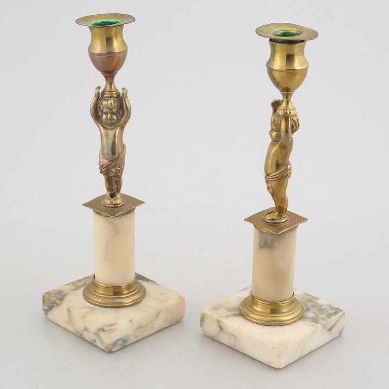 A pair of late Gustavians marble and brass candlesticks, circa 1800.