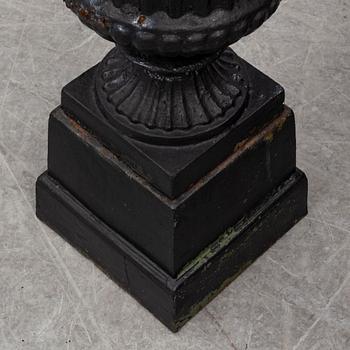 A pair of 20th century cast iron urns.