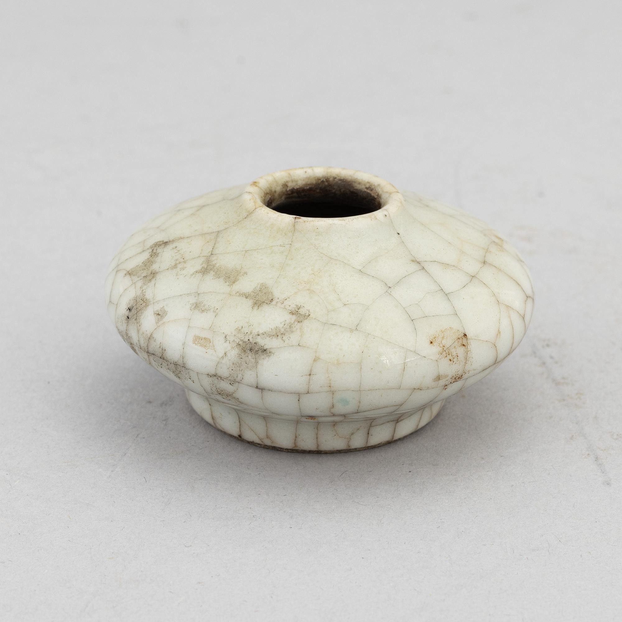 A Chinese celadon glazed lotus leaf shaped bowl, late Qing dynasty, and a ge-glazed brush washer, possibly 20 century.