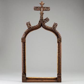 A possibly 16th century carved dark wood picture frame.