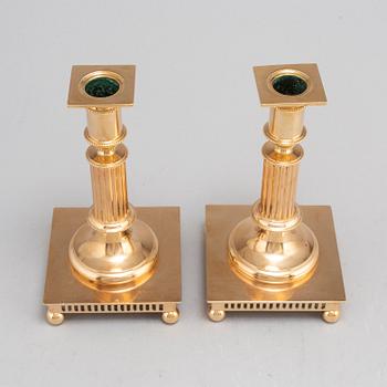 A pair of model 38 brass candlesticks from Gusums Bruk, first half of the 20th century.