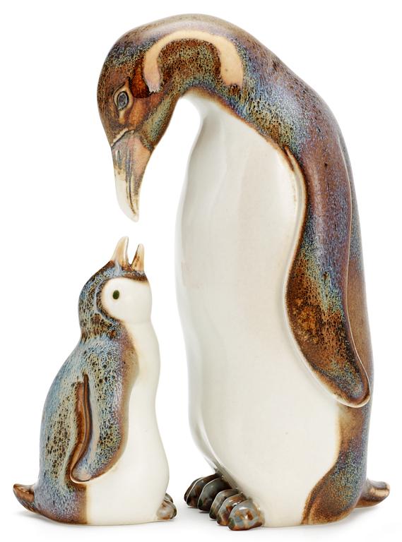 Two Gunnar Nylund stoneware figures depicting a penguin mother with child, Rörstrand.