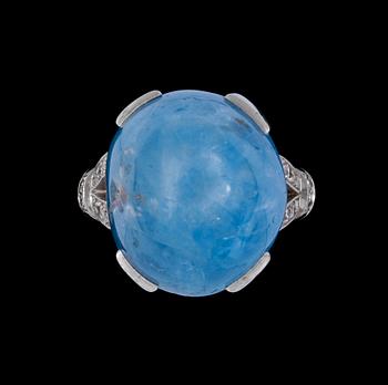 1294. A cabochon cut blue sapphire, app. 30 cts, and diamond ring.
