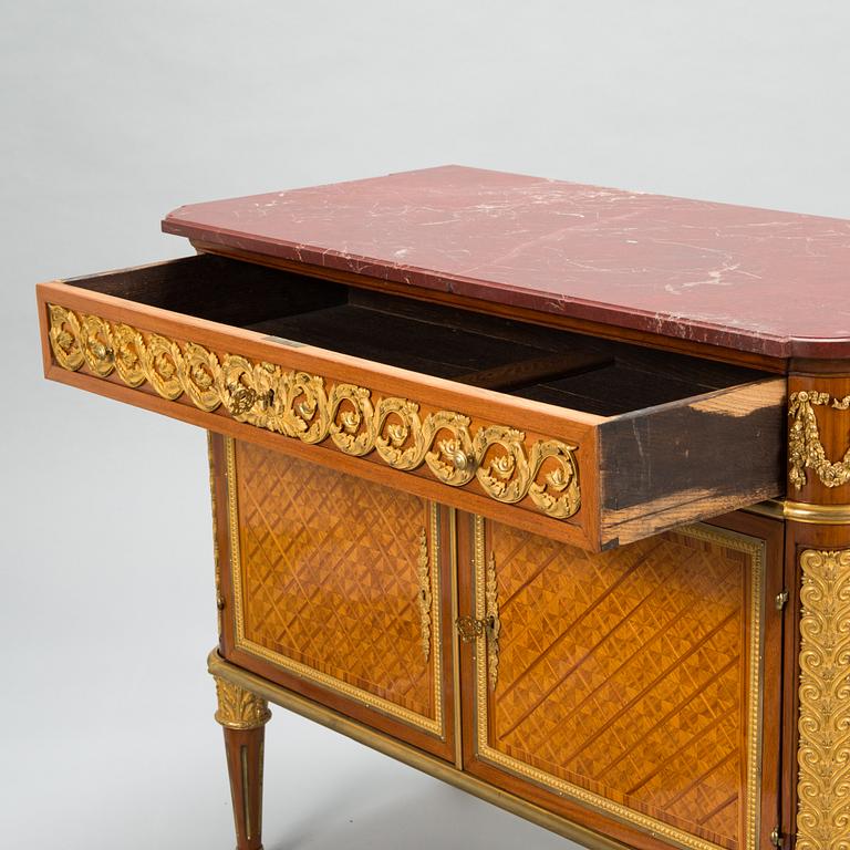 A French chest of drawer in Louis XVI style after Jean-Francois Leleu's school, late 19th century.