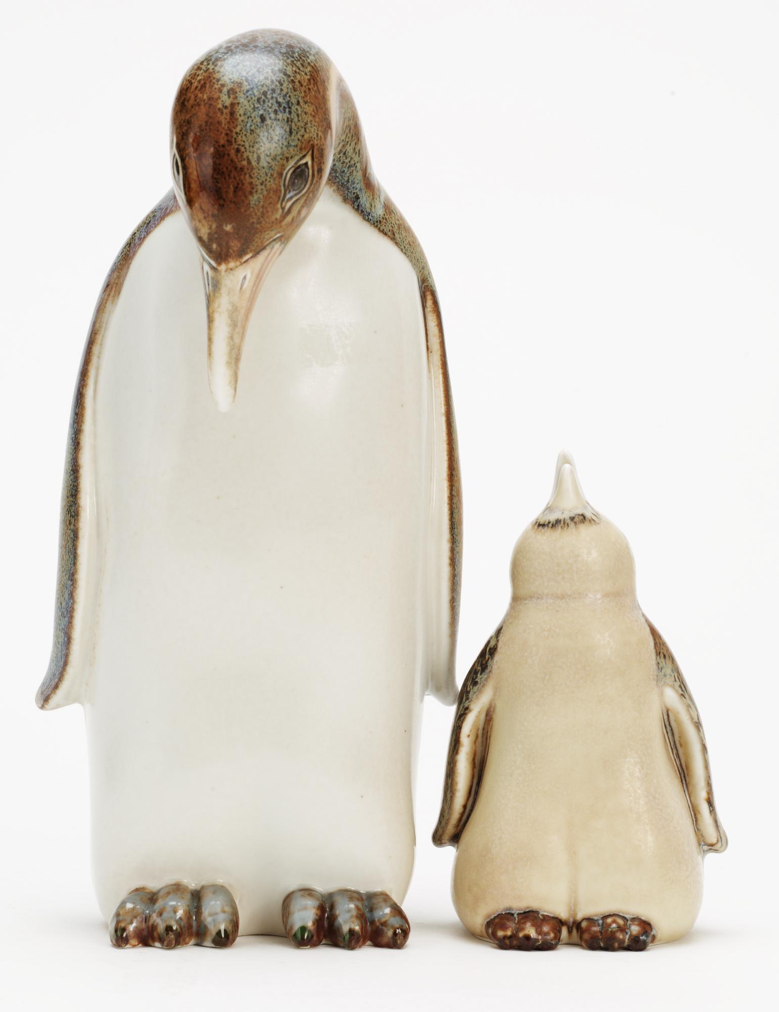 Two Gunnar Nylund stoneware figures depicting a penguin mother with child, Rörstrand.