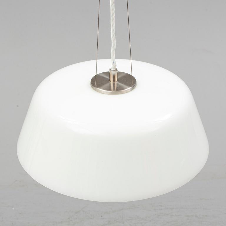 An Arne Jacobsen "Centenary Package" comprising three "Ant Chairs" and an eggshaped table, Fritz Hansen, Denmark.