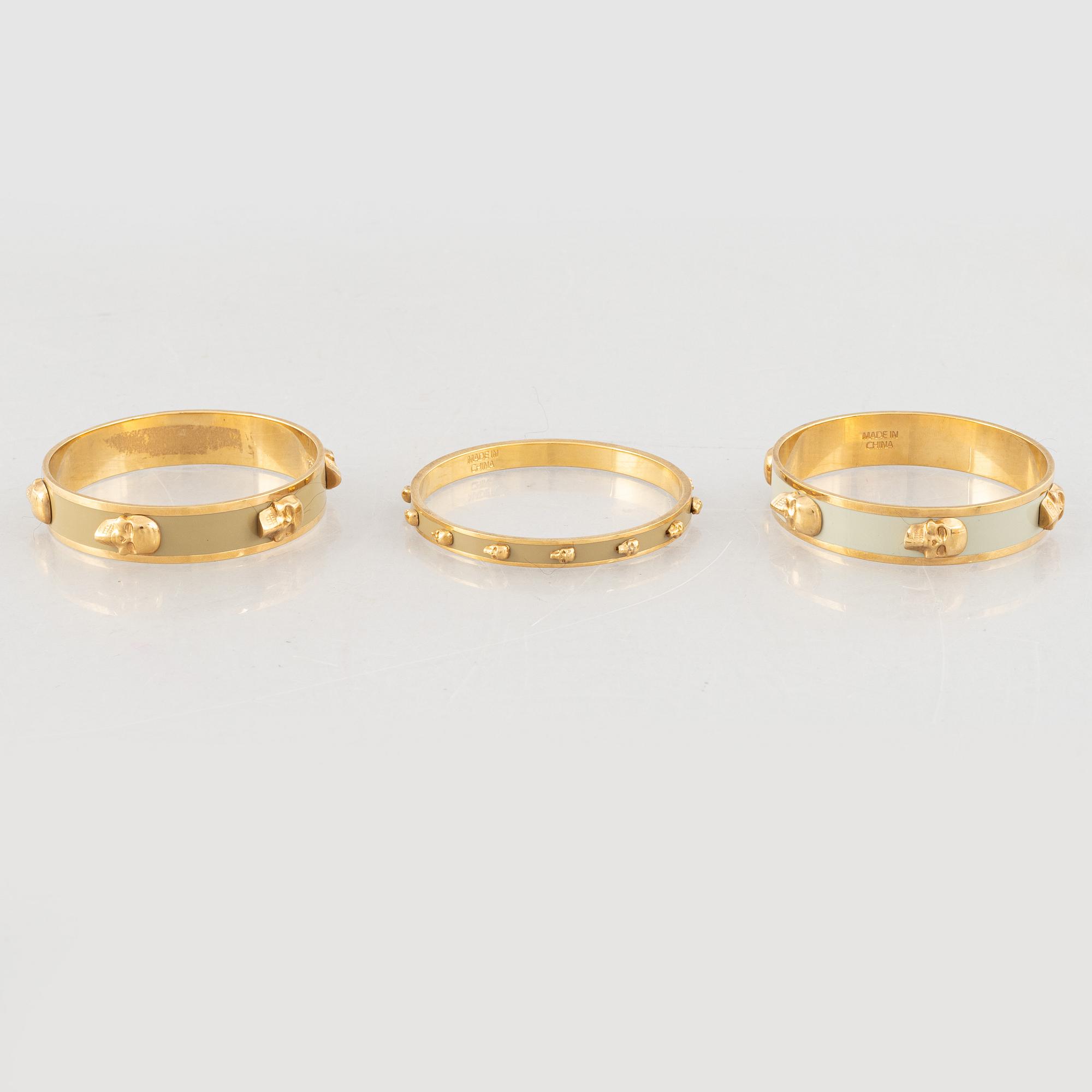 Alexander McQueen, three bracelets and a ring.