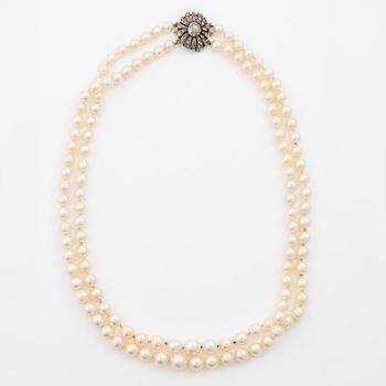 Two-row cultured pearl necklace with a silver and 18K gold clasp set with rose-cut diamonds.