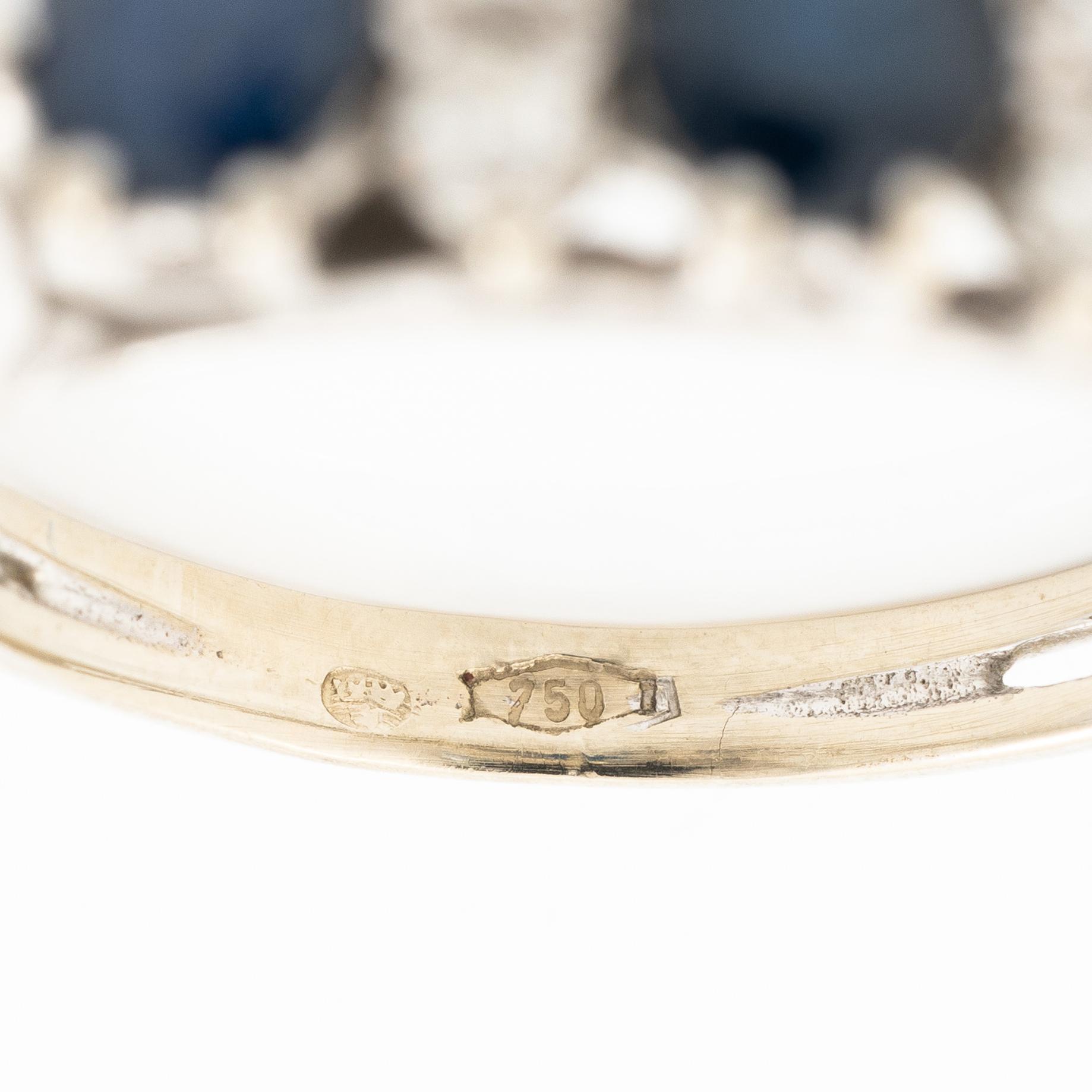 Ring, 18K white gold, set with three sapphires and single-cut diamonds.