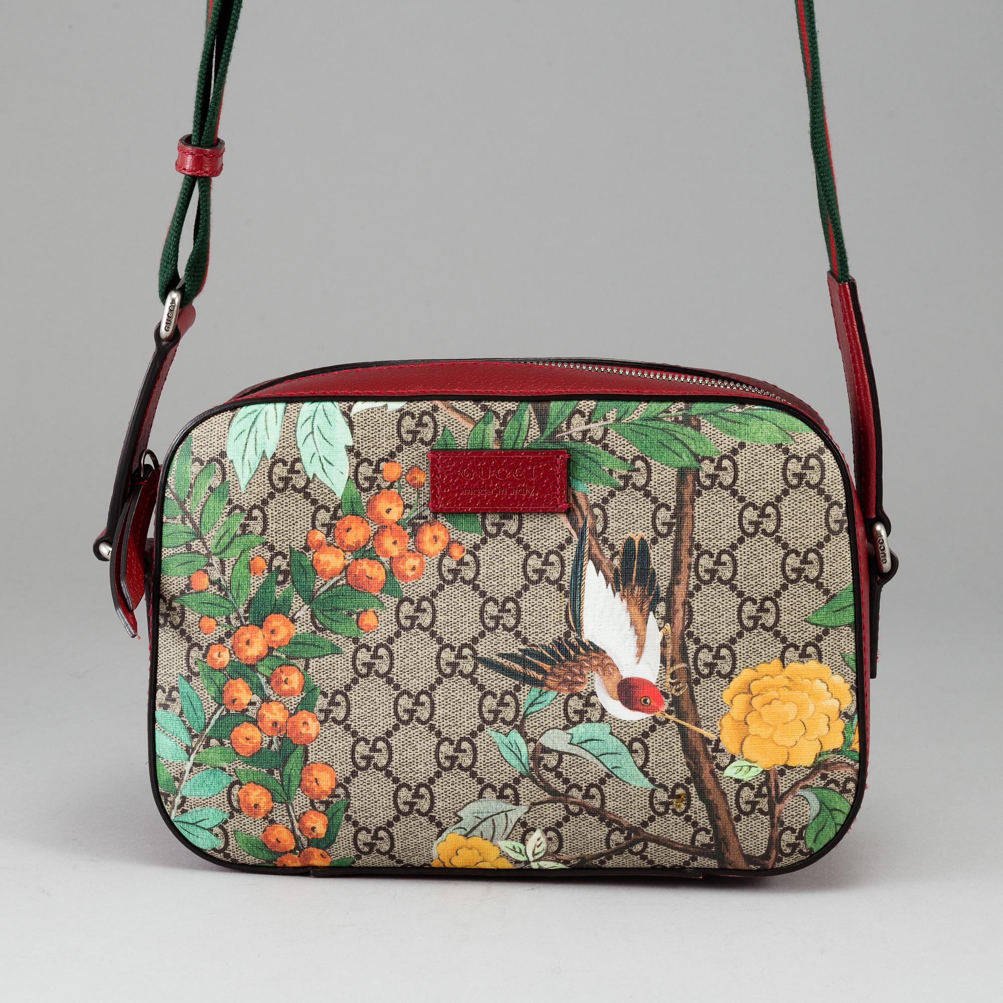 GUCCI, a patterned monogram canvas and leather bag.