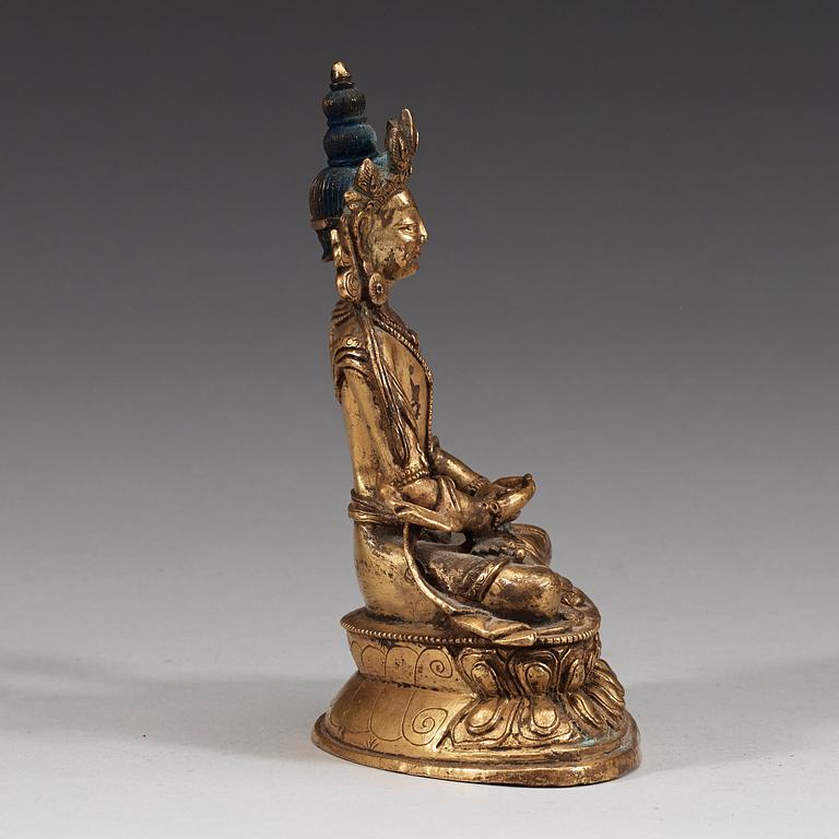 A seated Sino-Tibetan gilt bronze figure of Amitauys, 18th Century.