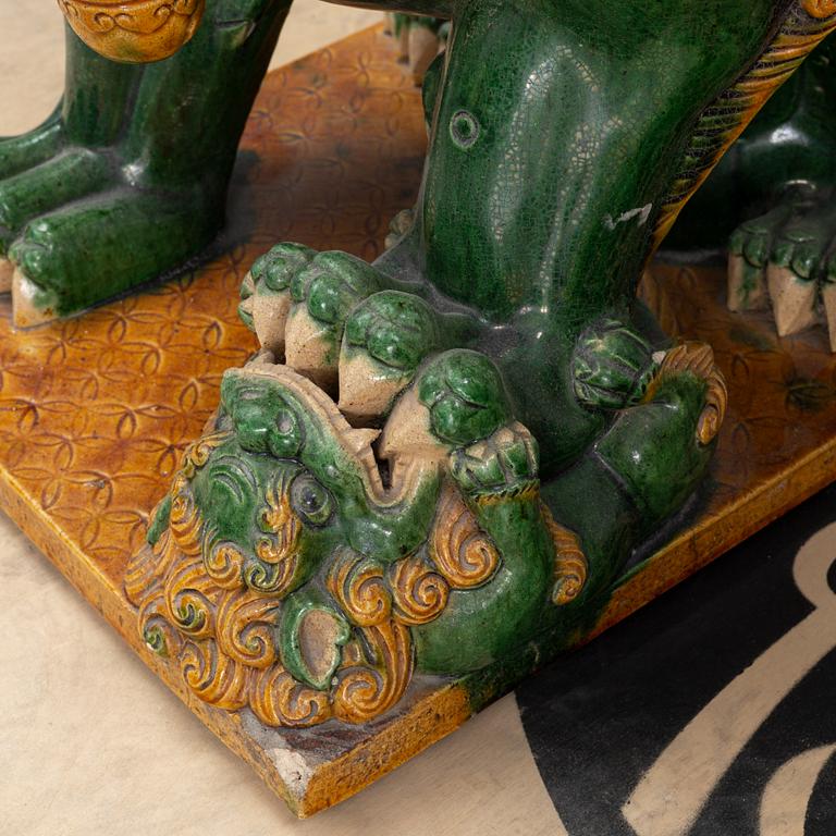 A pair of sancai-glazed chinese buddhist lions or guardian lions, early 20th century.