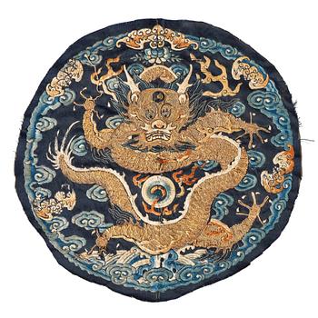 1054. An embroidered dragon roundel from the surcoat of an Emperor or Imperial son, Qing dynasty, 18th century.