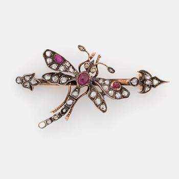 518. A silver and gold brooch set with rose-cut diamonds and cabochon-cut rubies.