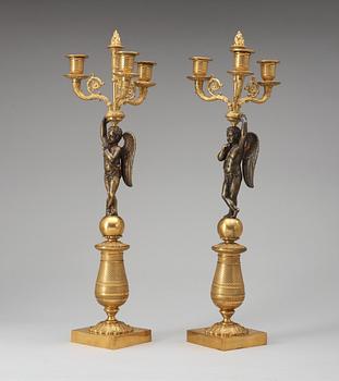 A pair of French Empire early 19th century three-light candelabra.