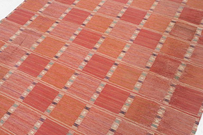 Barbro Nilsson, a carpet, 'Falurutan, röd Borås', flat weave, c. 502 x 212 cm, signed AB MMF BN.