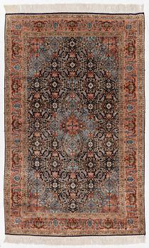 An oriental silk rug, c.. 198 x 123 cm.