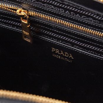 PRADA, a leather bag.