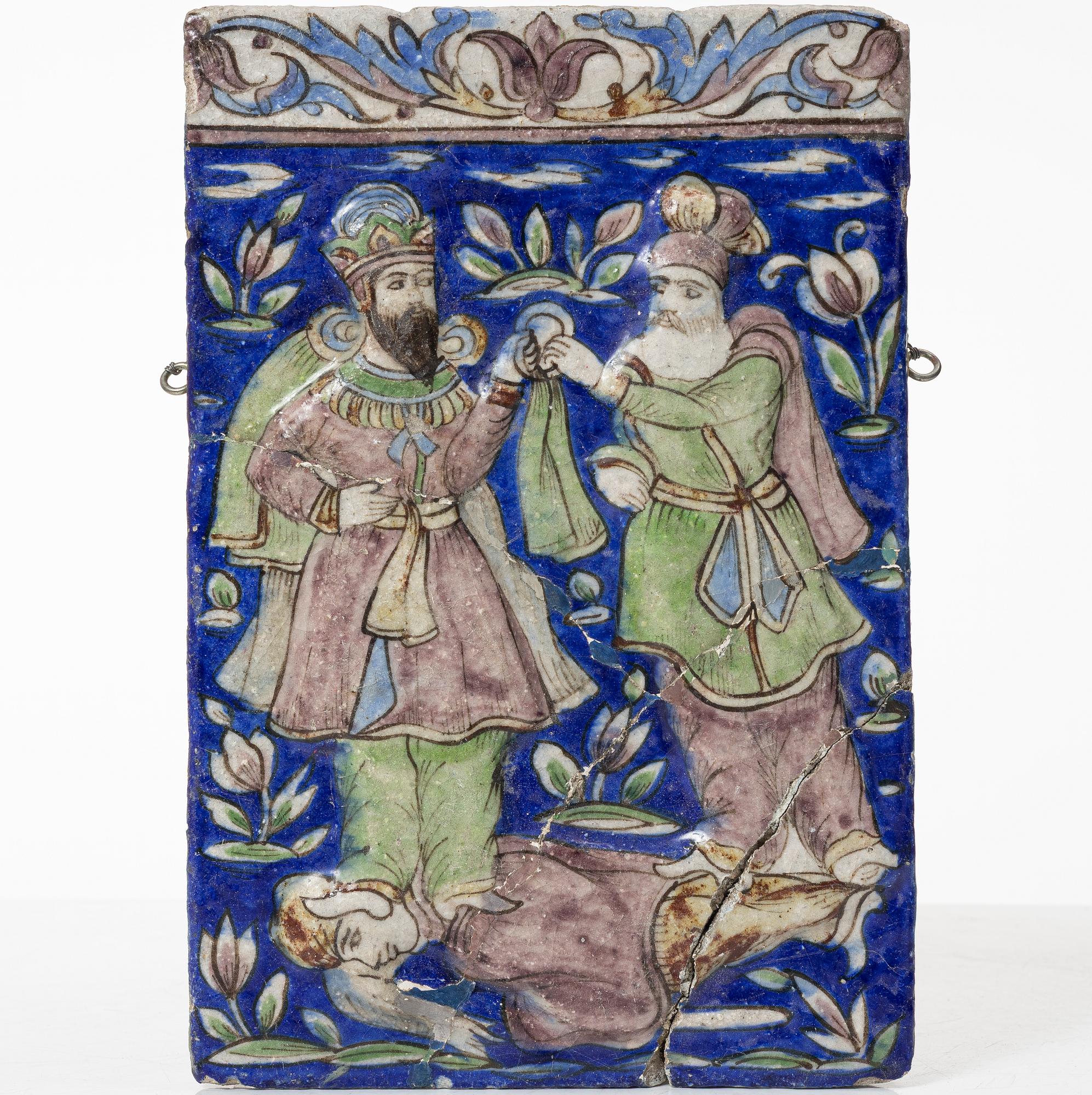A Qajar moulded figural pottery tile, ca 26 x 19 cm.