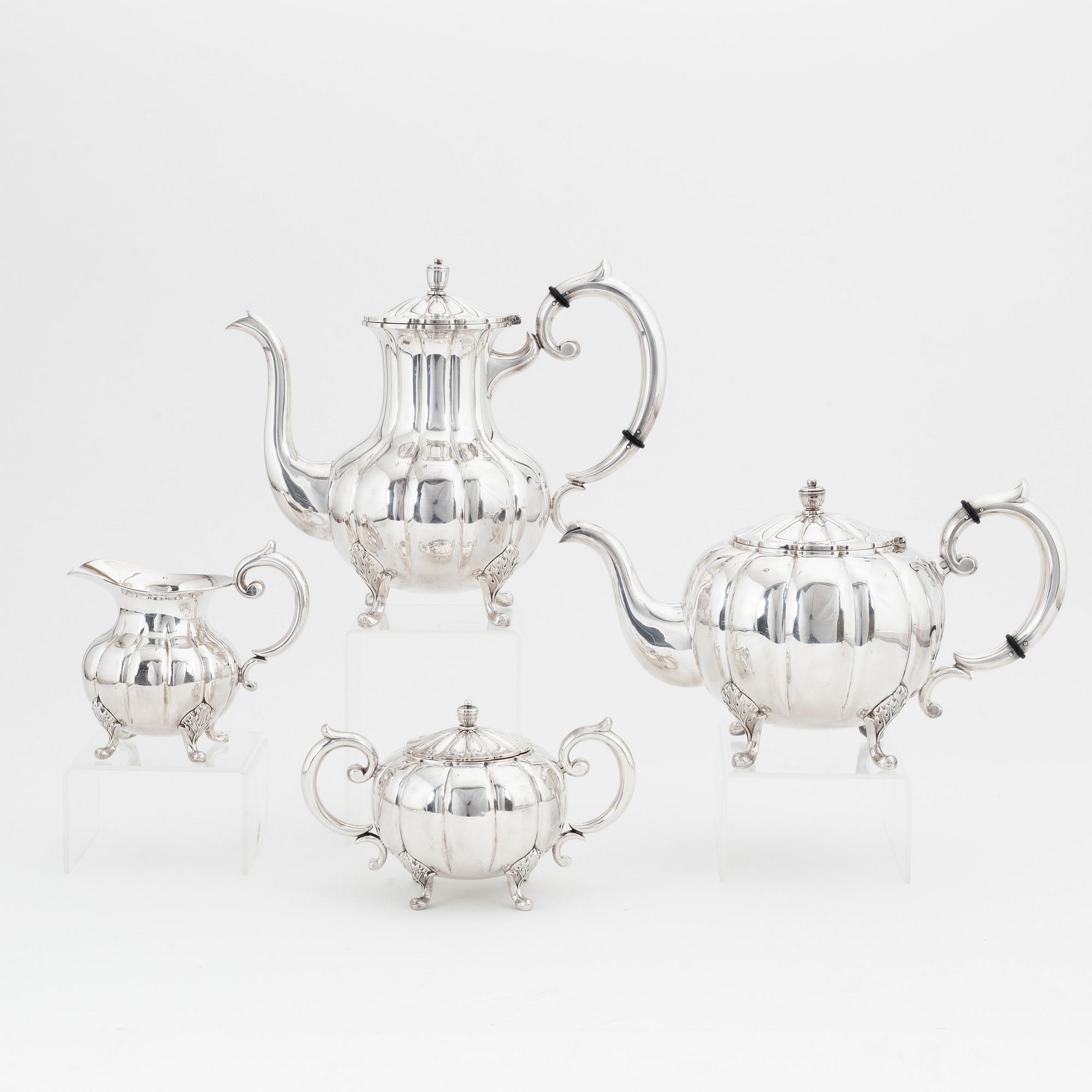 A rococo style sterling silver teapot, coffee pot, creamer and sugar bowl.