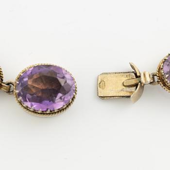 Garniture, necklace and bracelet silver with amethysts, brooch gold-coloured metal with purple paste stones,