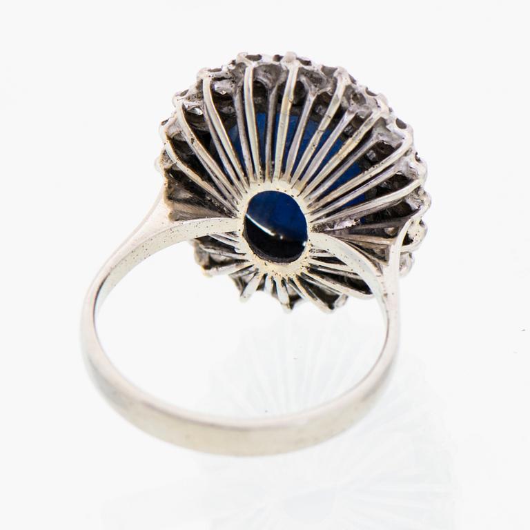 A RING, cabochon cut star sapphire, brilliant cut diamonds, 18K white gold.