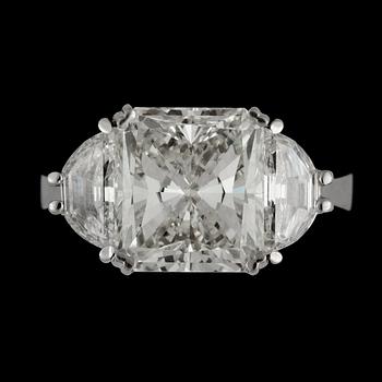 A radiant cut 5.02 cts diamond ring flanked by two half-moon shaped diamonds, totally 1 ct.