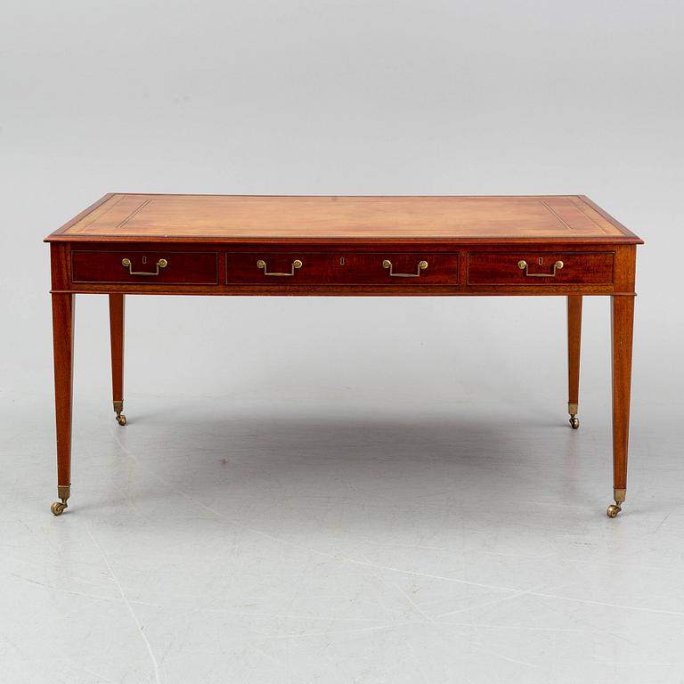 A contemporary mahogany and leather partners desk in the George III style.