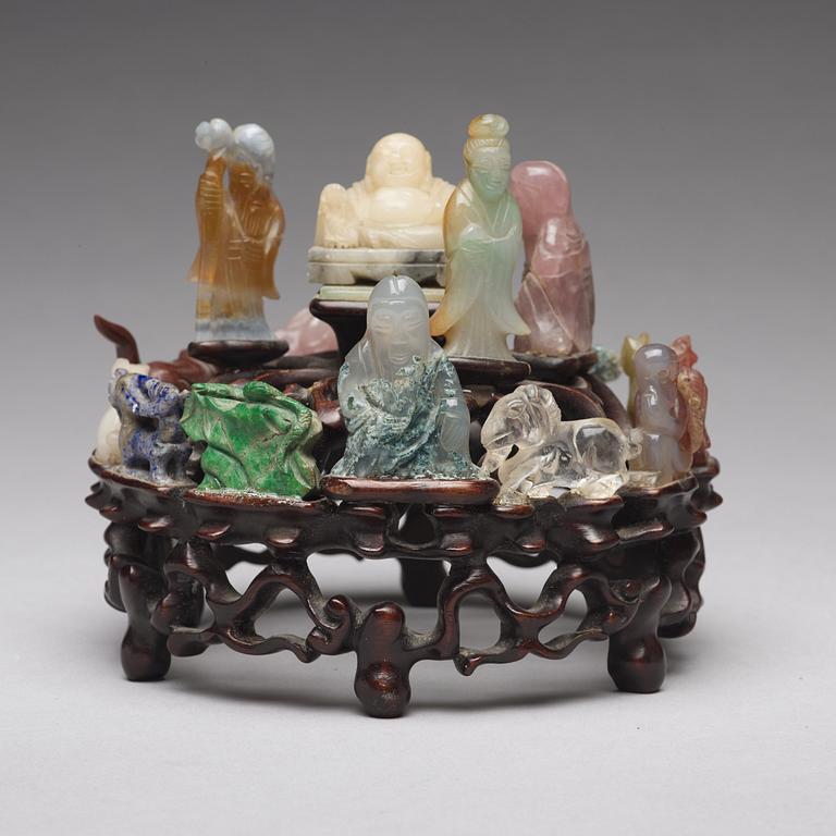 An arrangement of stone sculptures on a wooden stand, China 20th Century.