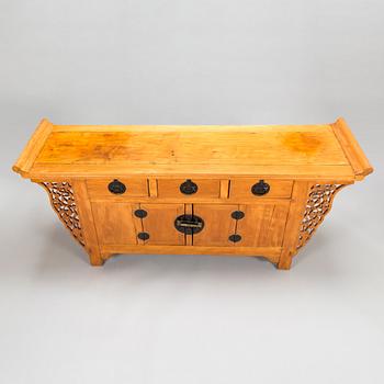 A Chinese elmwood sideboard, from around the turn of the century 1900.