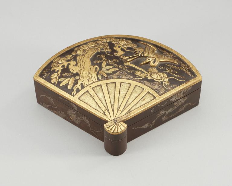 A Japanese fan-shaped gilt and silvered bronze box with cover, Meiji, circa 1900.