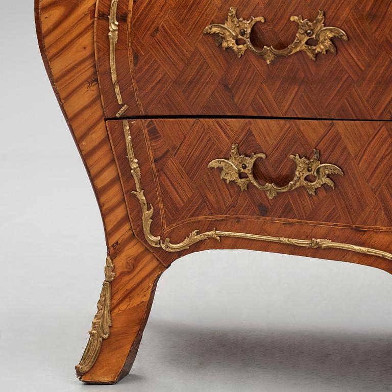 A rococo rosewood-veneered and ormolu-mounted commode by N. Korp (master 1763-1800).