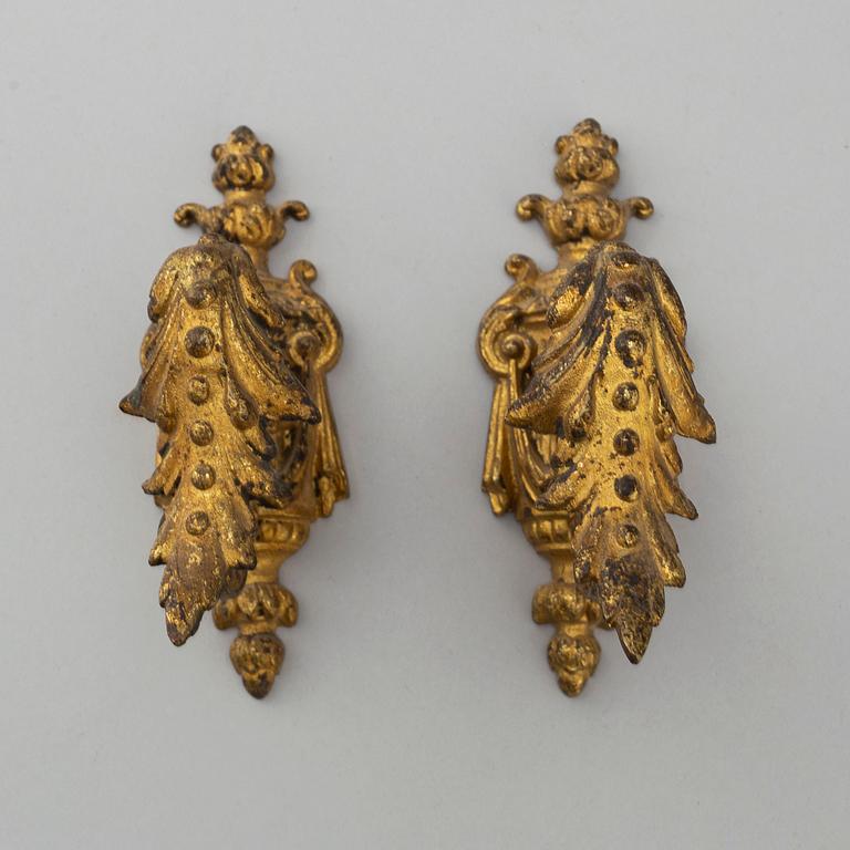 Three pairs of bronze and brass tie-backs, 19th century.