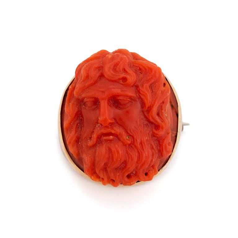 A 14K gold and coral cameo brooch.