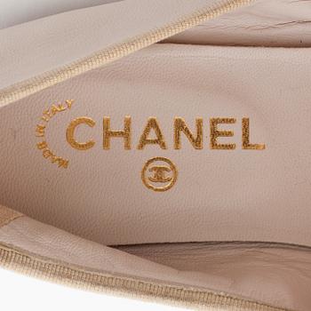 CHANEL, a pair of beige leather ballet flats.