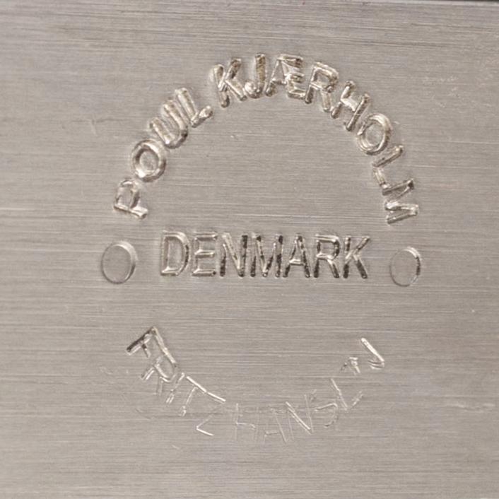 A Poul Kjaerholm PK61 glass table by Fritz Hansen.