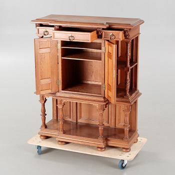 A cabinet in baroque style, made in the first half of the 20th century.