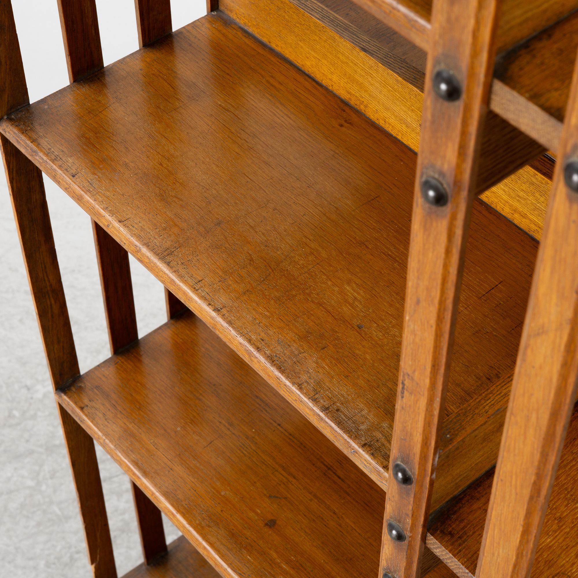 An oak Revolving bookcase by Trübner & Co, England, early 20th century.
