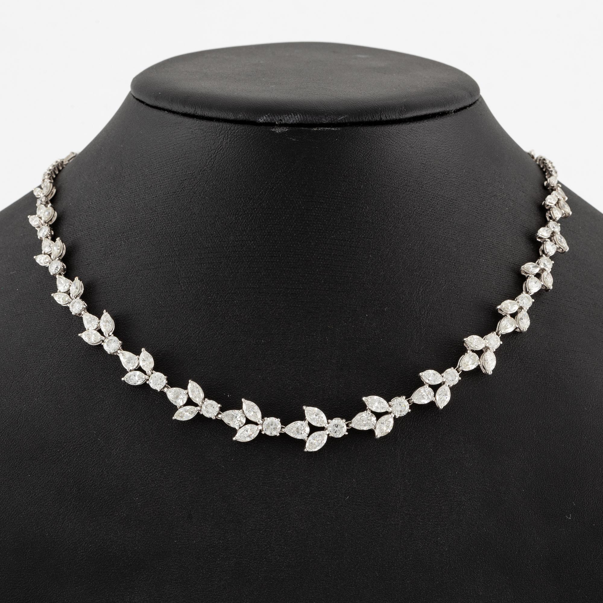 A platinum necklace set with navette-, pear- and round-brilliant-cut diamonds.