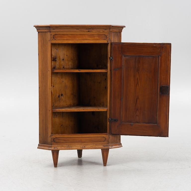 A Gustavian style pinewood corner cupboard, 19th Century.