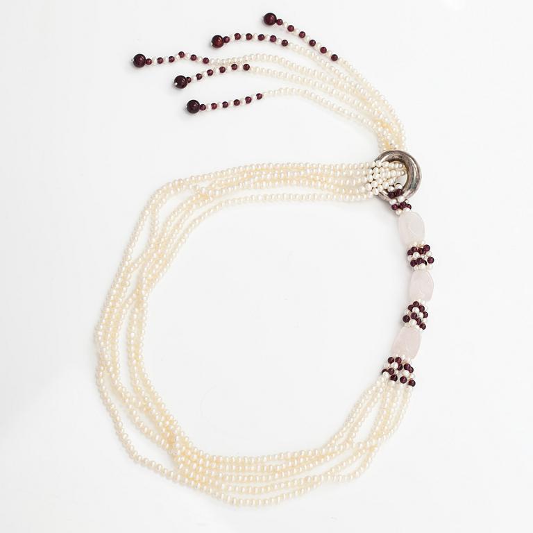 A sweet water, rose quartz, garnet and wood pearls collier with a Tiffany & co silver ring designed by Elsa Peretti.