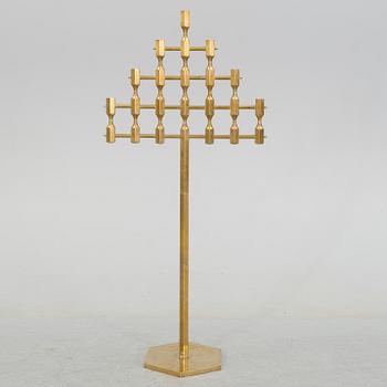 A brass floor candelabrum from Metallslöjden Gusum, signed BK and dated 1989.