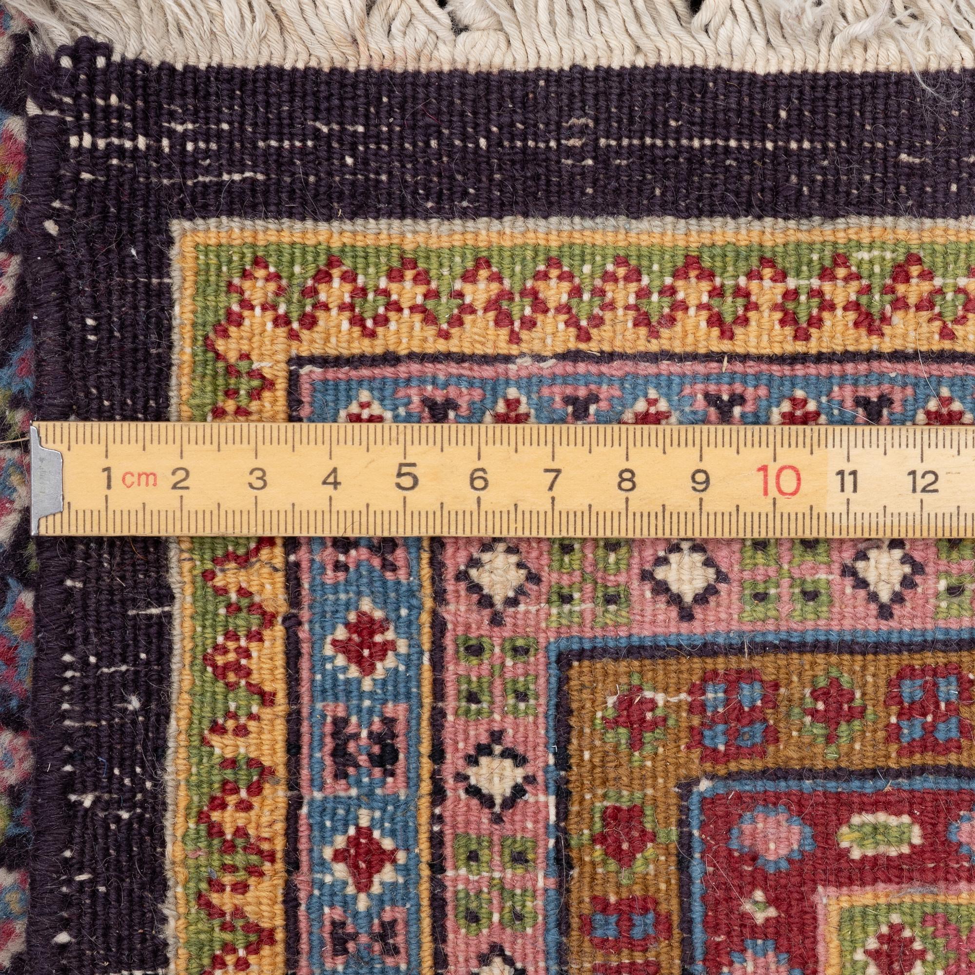 A oriental carpet, signed, c. 295 x 295 cm.