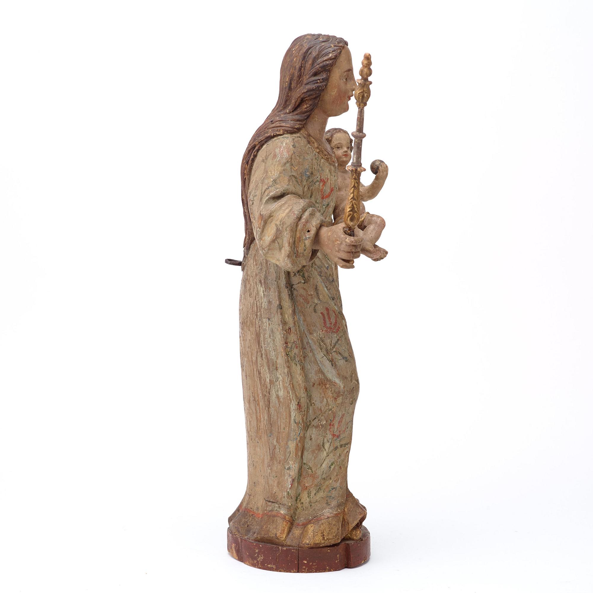 A Baroque 18th century sculpture depicting Mary with baby Jesus.